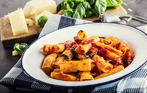istock Pasta Rigatoni with tomato sauce basil leaves and parmesan cheese. 517567868