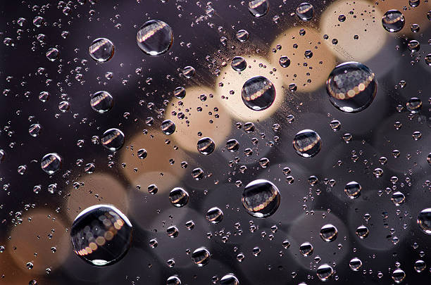 istock Close-up on water drops background on creamy and black surface. 517569542