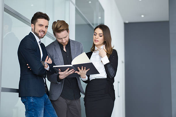 istock Young business team working on business reports in a hallway. 517570278