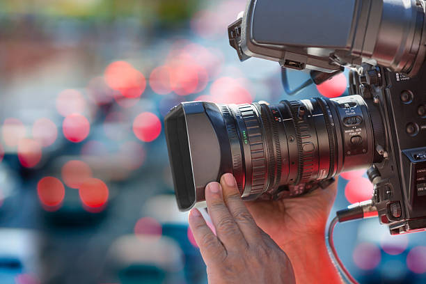 istock Close up cameraman at work outdoors 517570626