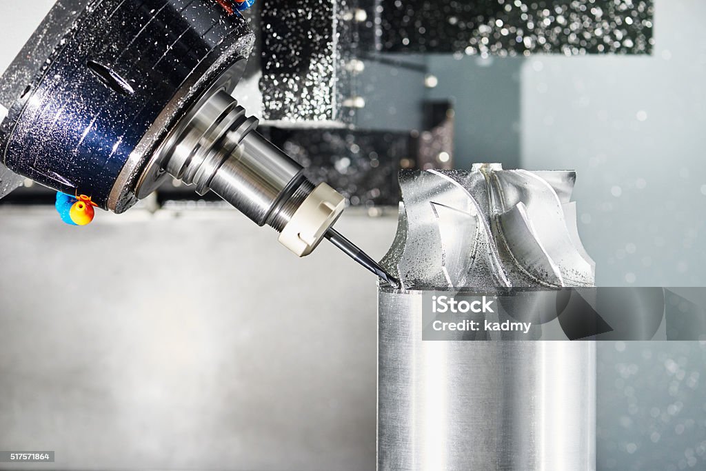 cnc metal working machining center with cutter tool cnc metal working machining center with cutter tool during metal detail milling at factory. Authentic shooting in challenging conditions. CNC Machine Stock Photo