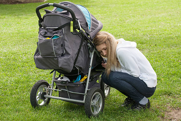 istock Young mother and son in stroller 517573536