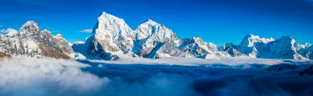 istock Dramatic mountain peaks panorama snowy summits above clouds Himalayas Nepal 517574346