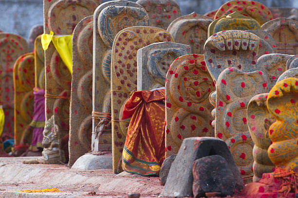 Group of yellow monuments with red dots in Shiva temple Group of yellow tombs with red dots in Shiva temple, Kanchipuram, Tamil Nadu lingam yoni stock pictures, royalty-free photos & images
