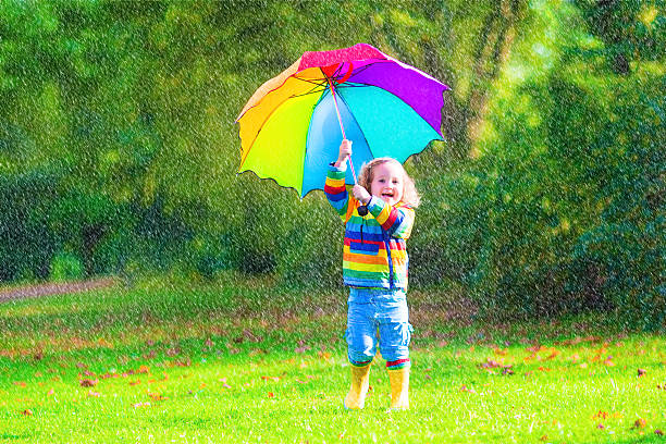 istock Cute little girl with umbrella 517576991