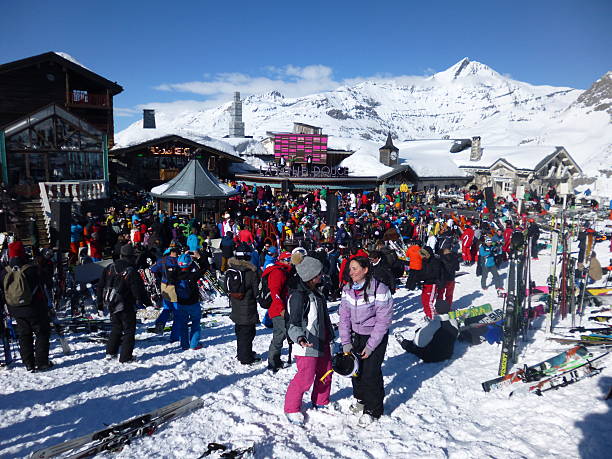 Party on the Slopes Val d'Isere, France - March 17, 2016: A busy bar on the slopes as people party in the sunshine apres ski stock pictures, royalty-free photos & images