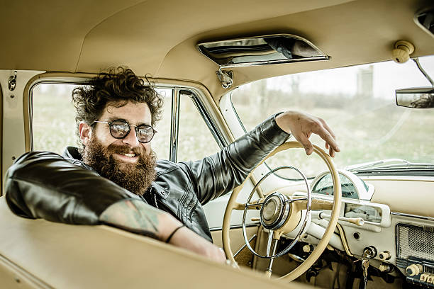 istock Bearded man behind the wheel of a retro car 517577868