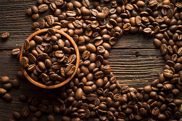 istock Coffee cup and saucer on a wooden table. Dark background. 517578074