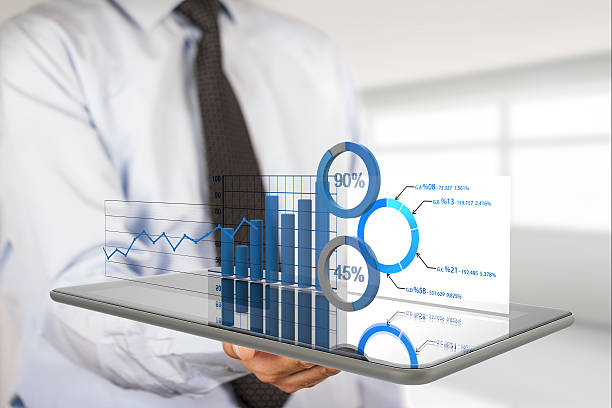 istock Diagrams and charts projecting from tablet 517578214