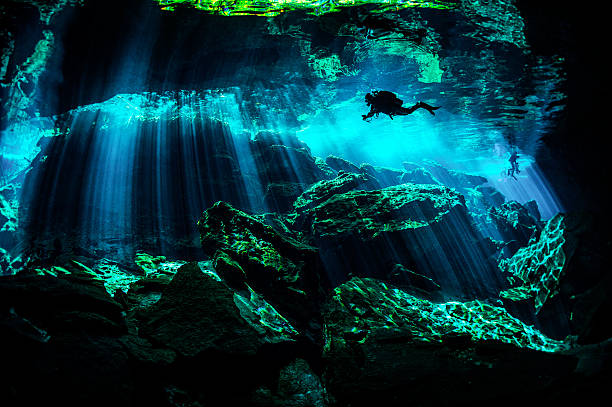 Mexico caverns Scuba diver exploring the underwater caverns. cenote stock pictures, royalty-free photos & images