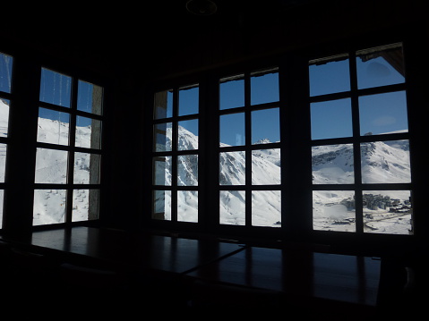 Snowy Alps viewed through the window pane.