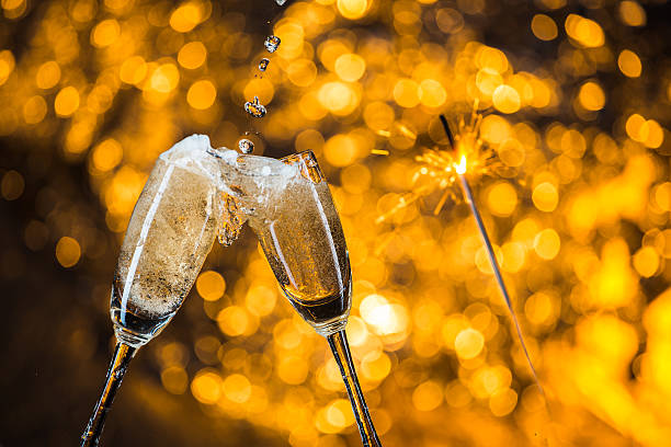 istock New Year's at midnight with champagne glasses on light background 517580106