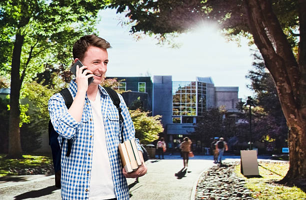 istock Smiling student at campus and talking on phone 517580632