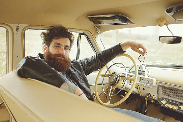 istock Bearded man behind the wheel of a retro car 517580908