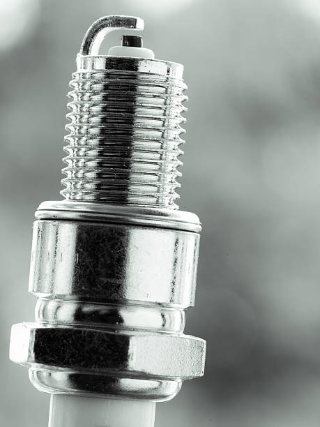 istock Auto service. New spark plug as spare part of car. 517581619