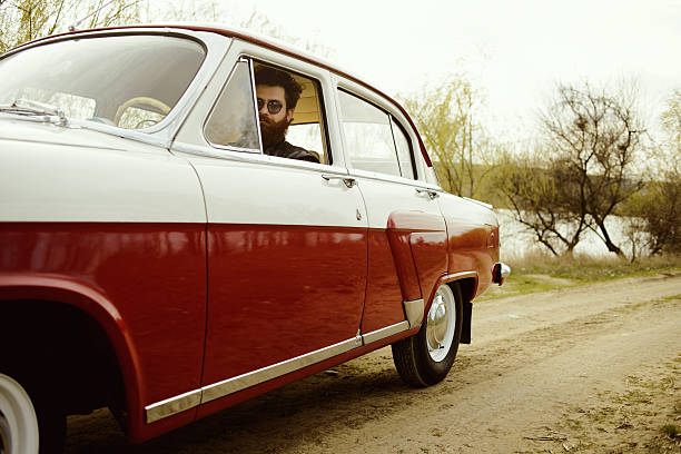 istock Bearded man behind the wheel of a retro car 517582014