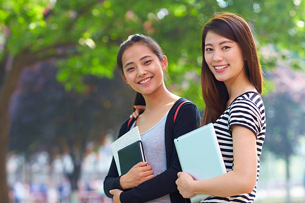 istock two female asian college students in campus 517593305