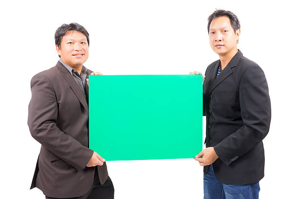 istock business man holding blank green board 517593659
