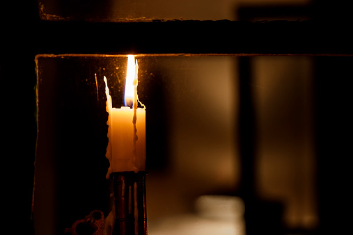 Candle in a window signalling hope and faith