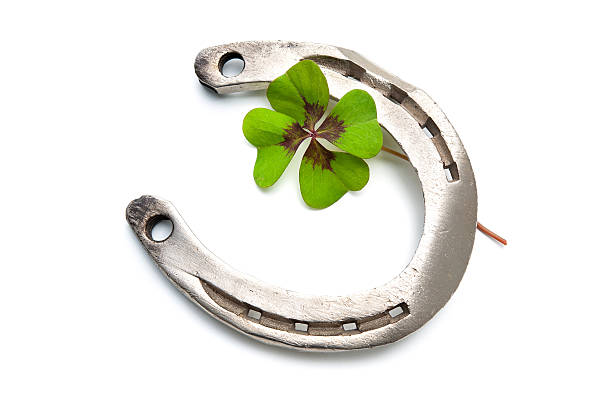 istock Horseshoes and four leaf clover 517596361