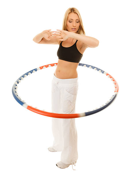 istock sporty fit girl doing exercise with hula hoop. 517596667