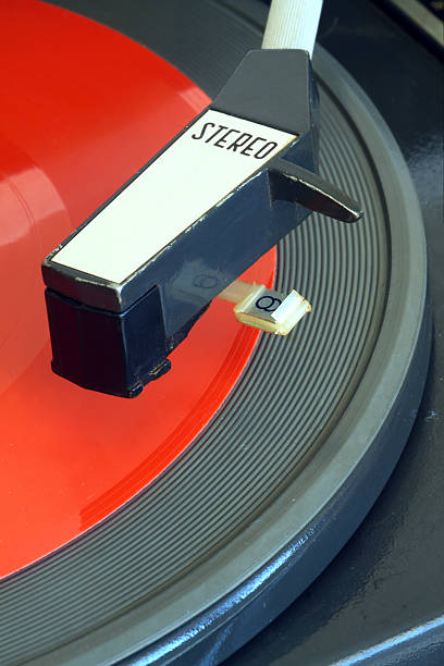 istock Vintage turntable with red red flexible disc closeup 517598644