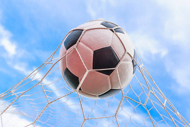 istock soccer ball in goal net 517599427