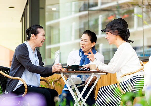 istock Elderly Asian Women Cheerfully Chatting In An Outdoors Cafe 517599500