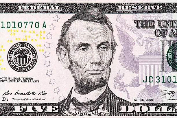 Macro of image the face of Abraham Lincoln on the Five American Dollar Bill.