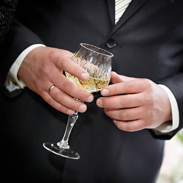istock wine glasses in hand bride and groom. 517600377