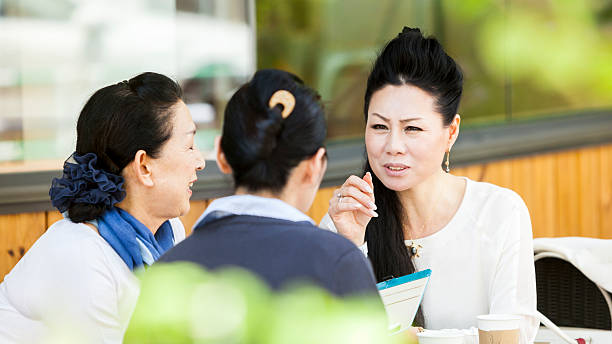 istock Elderly Women Sharing Stories In An Outdoors Cafe 517600424