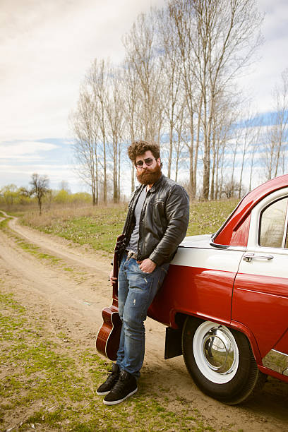 istock Bearded man behind the wheel of a retro car 517601280
