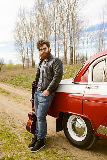 istock Bearded man behind the wheel of a retro car 517601320