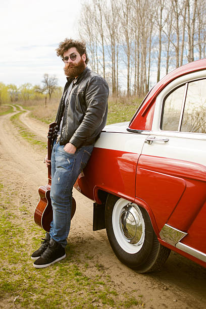 istock Bearded man behind the wheel of a retro car 517601366