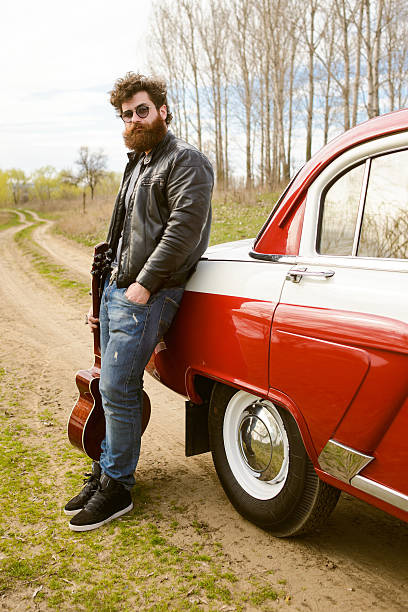 istock Bearded man behind the wheel of a retro car 517601410