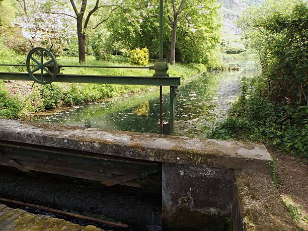 Ninfa, Latina, Lazio, Italy - February 17, 2015: Ancient gate to regulate the water flow of the Oasis of Ninfa channel