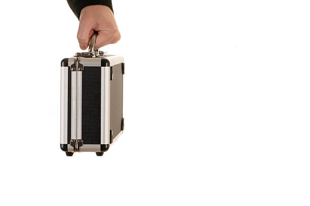 istock male hand holds a metal case 517609282