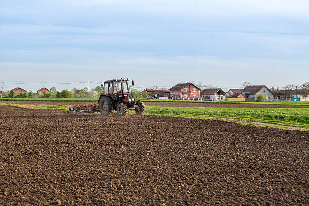 istock Farmer cultivating arable land before seeding 517609506