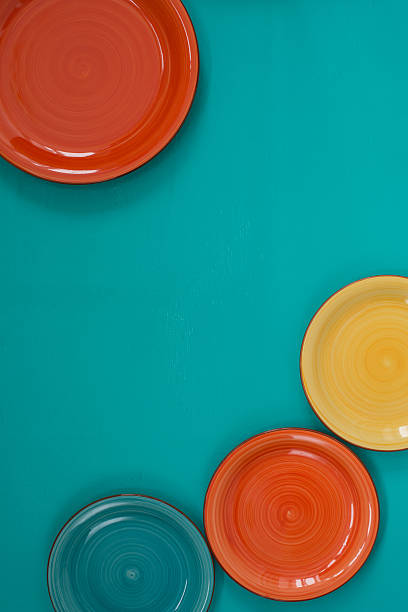 istock Colorful plates on turquoise background 517609912