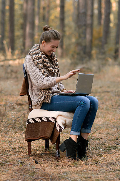 istock Smiling,happy,cheerful girl work at computer outdoors, good mood 517613600