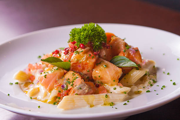 Meal of Salmon ceviche with penne and herbs