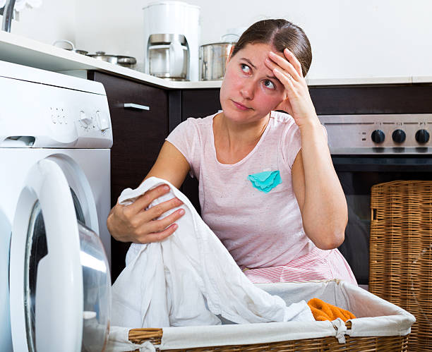 istock Unhappy woman with washing machine 517614222