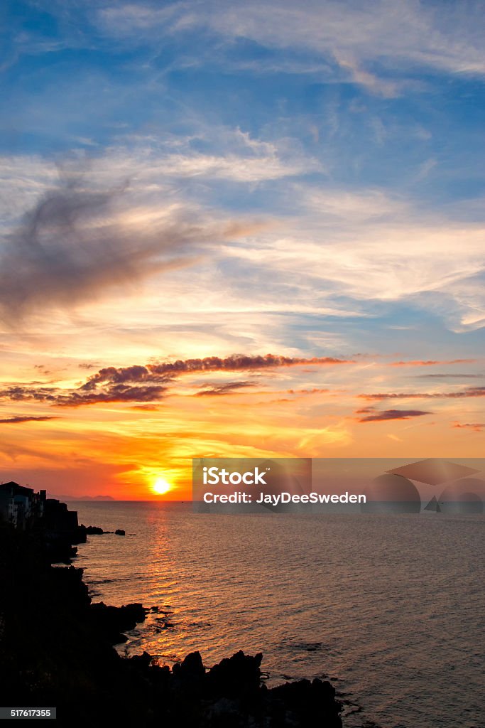 Sunset by the ocean in Sicily Sunset by the ocean in the village of Cefalu, Sicily. Awe Stock Photo