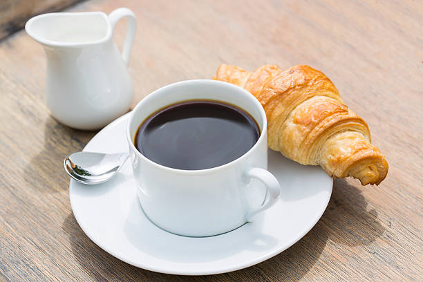 istock Breakfast with cup of black Coffee and Croissant 517620483