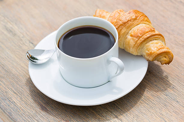 istock Breakfast with cup of black Coffee and Croissant 517620491