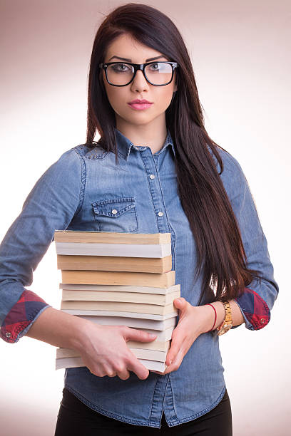 istock Young woman with books 517627030