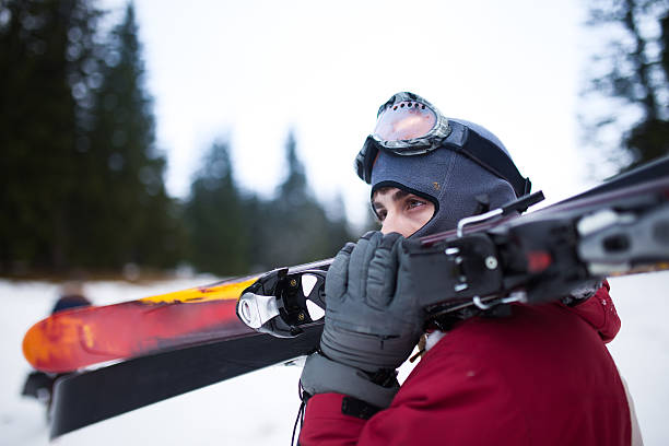 istock Young man holding ski equipment,having fun,active winter vacation 517627260