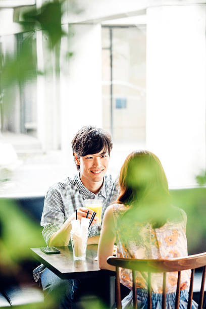 istock Young asian couple sitting in cafe. 517627566