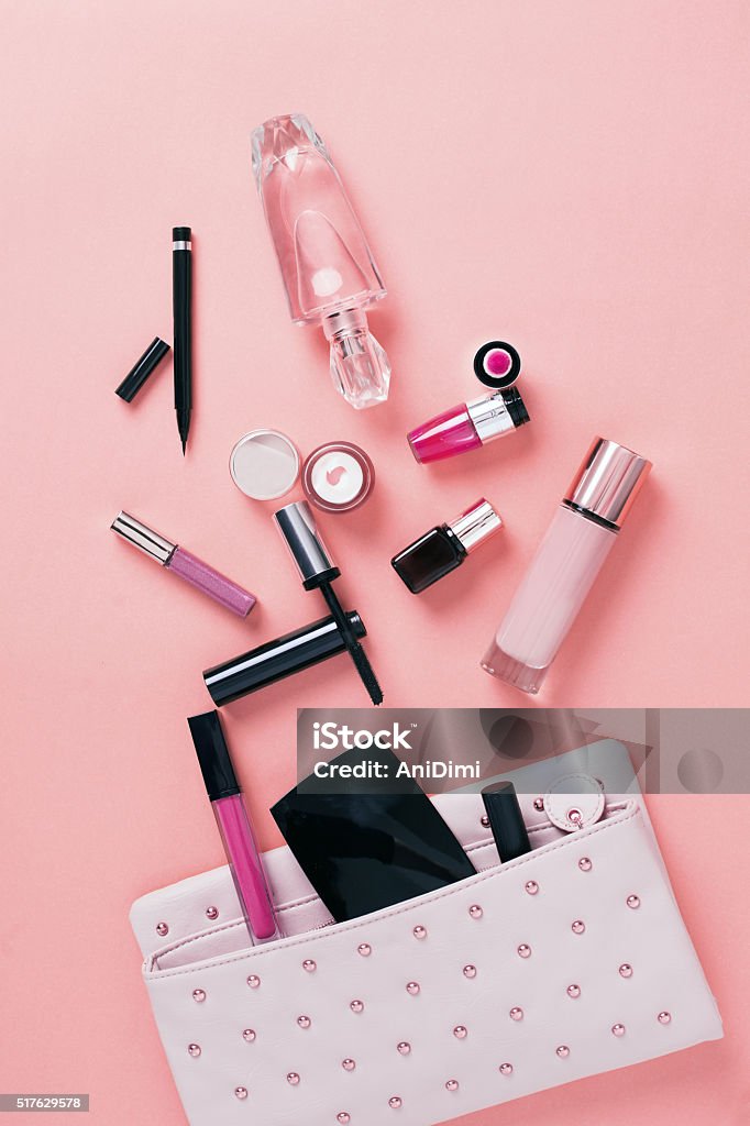 Make up bag with cosmetics Make up bag with cosmetics on pink background Perfume Stock Photo