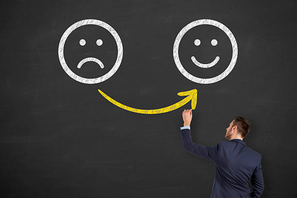 istock Hand drawing unhappy and happy smileys on blackboard 517629622